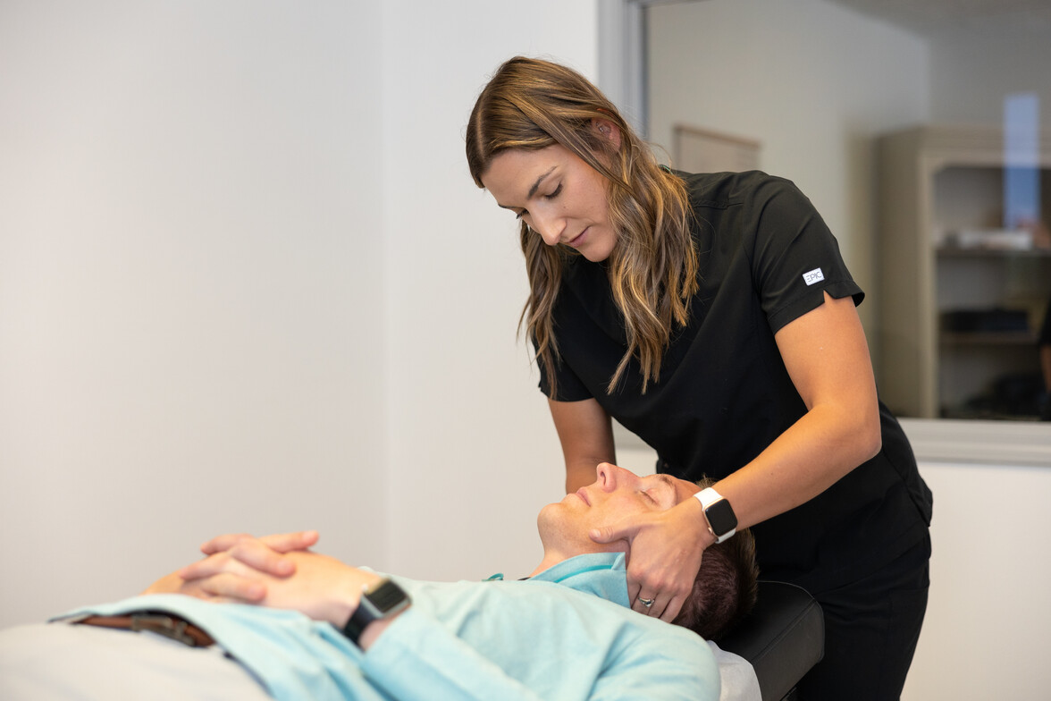 Chiropractor providing gentle adjustment to relieve TMJ pain